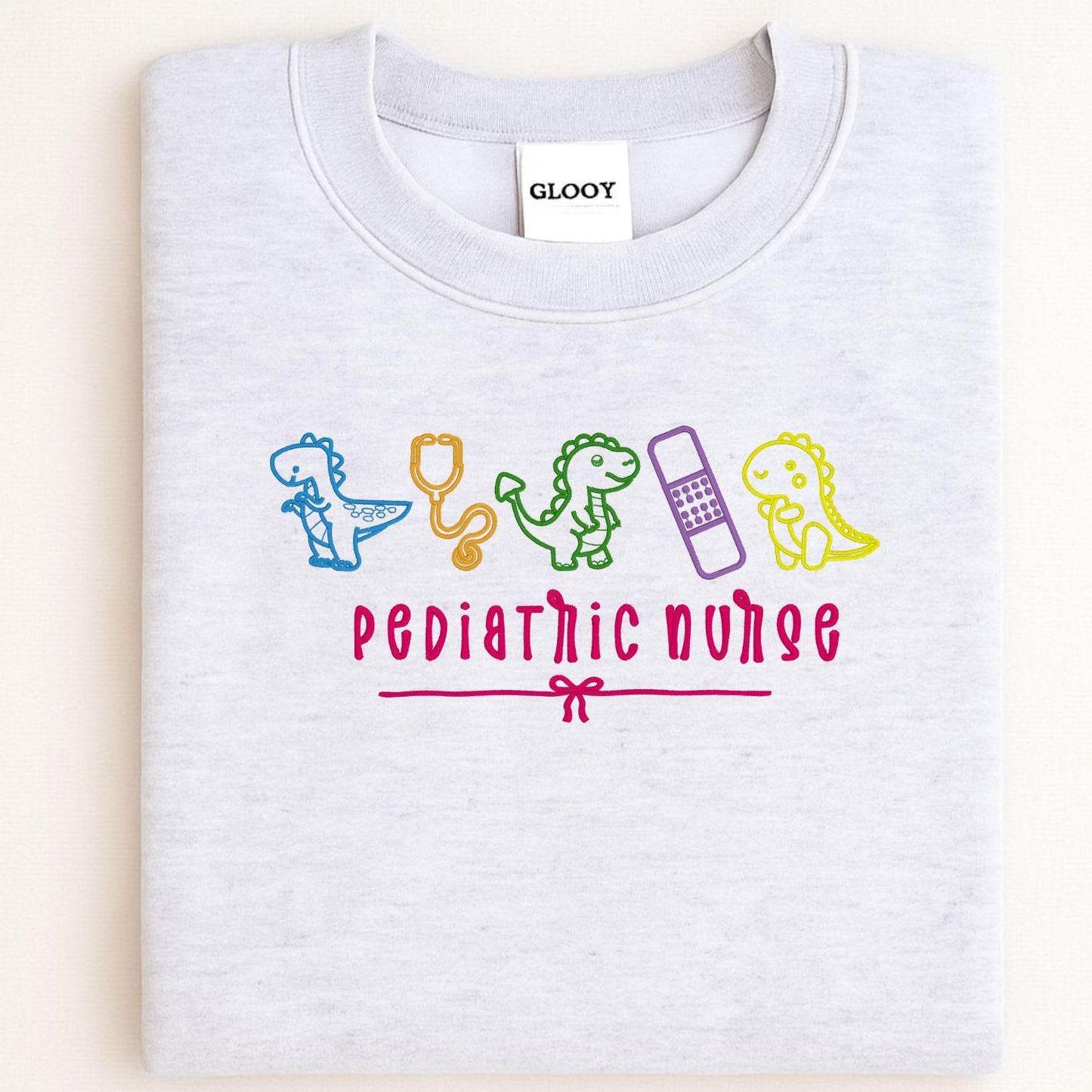 Pediatric Nurse Dinosaur Embroidery Sweatshirt – Cute Dino Medical Crewneck – Nurse Appreciation Gift – Colorful Stethoscope Design